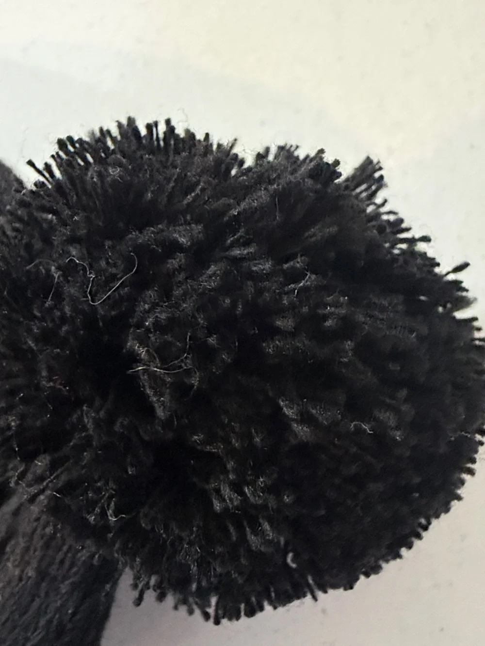 Black Pom Pom Knit Beanie with White Snowflake Pattern